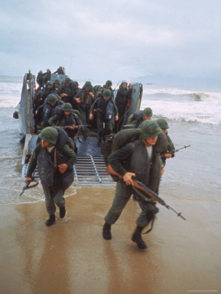 (Photo by  Larry.Burrows. LIFE Magazines. “Marines of 9th Expeditionary Brigade Coming Ashore at Red Beach 2”. Right-clicked from www.allposters.com, used here for non- commercial  purposes, under the terms of  free service by blog-use of image provided by said site.)